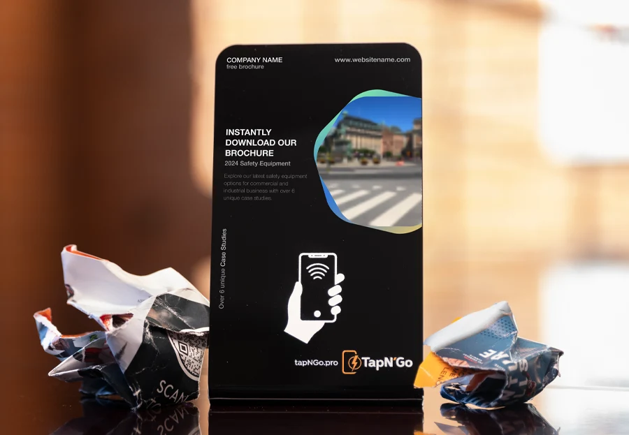 Photo of a black acrylic TapN'Go stand with custom print for instantly downloading a company brochure
